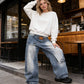 Jeans in denim a gamba larga con vita asimmetrica da donna
